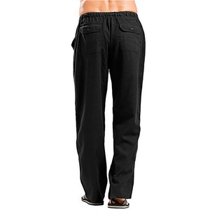 Detail view of black linen pants featuring elastic waistband and buttoned back pockets