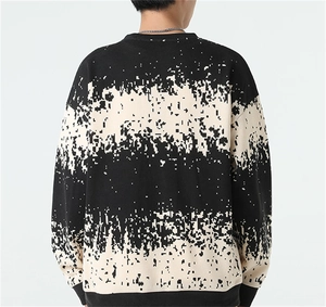 Rear view of loose fit men's knit sweater featuring black and white pixelated glitch pattern