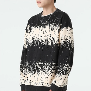 Detailed close-up of men's oversized knit sweater with black and cream pixelated stripes