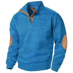 Close-up of blue knit pullover with brown suede elbow patches and stand collar detail