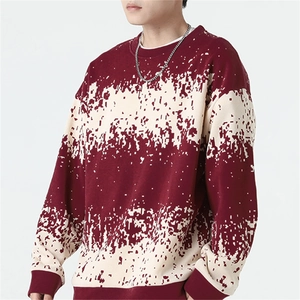 Detail of burgundy and cream pixelated knit pattern on men's long sleeve crewneck sweater