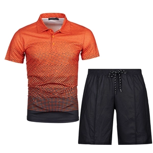 Detail of men's orange polo and black shorts with 3D geometric patterns and drawstrings