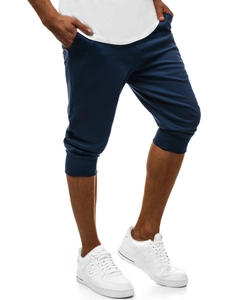 Dettaglio dei pantaloni sportivi blu scuro slim fit con polsini a costine e coulisse