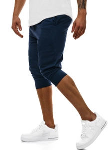 Dettaglio dei jogger blu scuro da uomo che mostra i polsini a costine e il tessuto elasticizzato