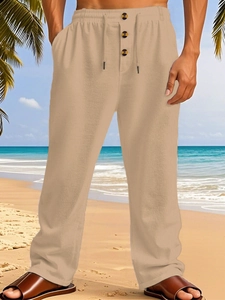 Detail of khaki linen beach pants featuring adjustable drawstring waist and decorative buttons
