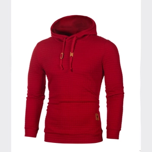 Close-up of the waffle texture fabric and leather label on this red hoodie