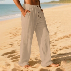 Detail of men's linen beach trousers with drawstring elastic waist and button fly