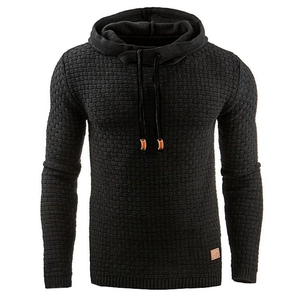 Detail of black textured knit hoodie showing the 3D brick pattern and brown leather label