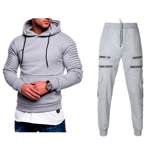 Detail of grey men's tracksuit featuring pleated shoulder patterns and zip cargo pockets