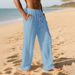 Men's breathable light blue cotton linen trousers with drawstring waist on sunny beach