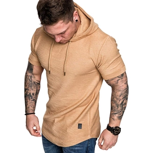 Detail of camel textured knit hooded T-shirt showing curved hem and rolled sleeve cuffs