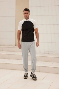 Men's loose jogger pants with side snap buttons and striped athletic detailing