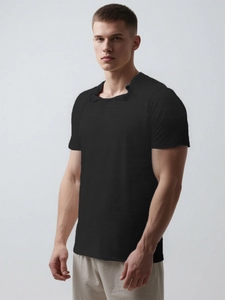 Detail of black adaptive recovery shirt showing square snap neckline and textured fabric