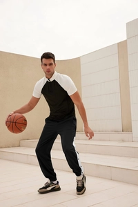 Men's athletic tracksuit with half-zip t-shirt and side-button jogger pants on model