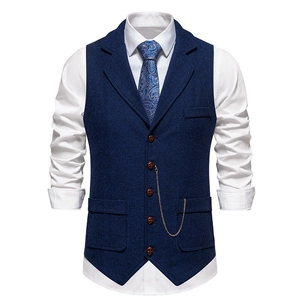 Detail of dark blue herringbone vest featuring a notched lapel and golden watch chain