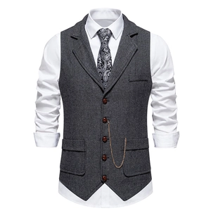 Detail of grey herringbone vest featuring suit lapel, five buttons and decorative chain