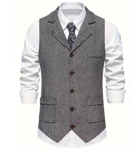 Close-up of grey herringbone vest showing five-button closure and classic pocket details