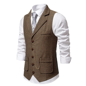 Detail of brown herringbone tweed vest featuring notch lapels and a vintage gold chain