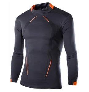 Detail of dark gray compression sport shirt with orange seams and breathable fabric