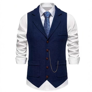 Men's navy herringbone vest with lapel and metal chain accessory on a white background