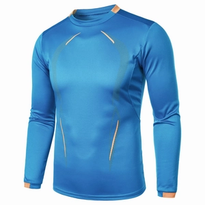 Detail of blue compression shirt showing orange stitching and breathable fabric texture