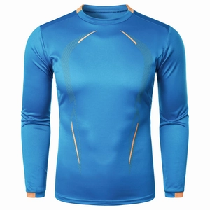Detailed view of royal blue athletic compression shirt with orange contrast stitching