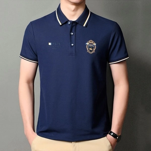 Detailed view of navy blue polo shirt featuring crown embroidery and PO-78 chest prints