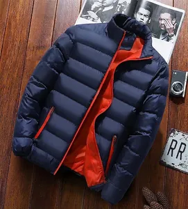 Détail d'une veste matelassée bleu marine avec doublure orange sur fond bois