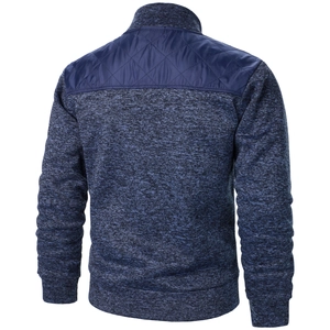 Detail of navy blue knit cardigan with quilted nylon back panels and ribbed cuffs