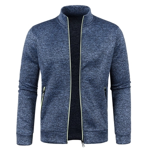 Detail of blue heather knit jacket with fluorescent yellow trim on zip pockets