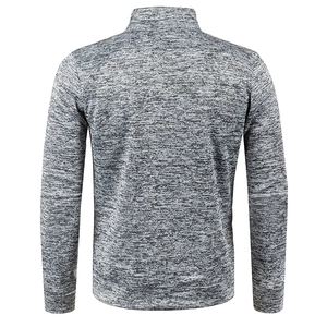 Macro shot of grey marl knitted fabric texture on men's thermal zip-up jacket