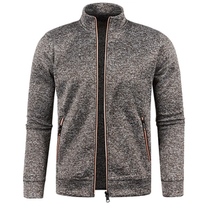 Detail of grey marl knit sweater with stand collar and contrasting orange zipper trim