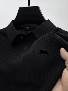 Detail of black ice silk Polo shirt with brick texture and classic button collar