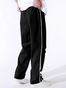 Side view of men's casual cargo pants with white stripes and elastic waist in black