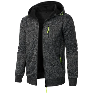 Detail of dark grey zip-up hoodie featuring contrast lime green zipper pulls and pocket