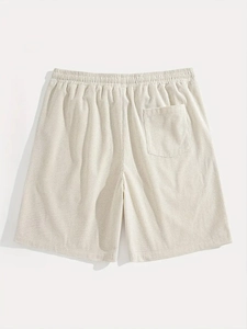 Detail of white waffle knit shorts showing elastic waistband and back pocket feature