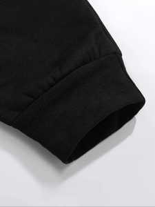 Detailed macro view of black ribbed knit cuffs showing high-quality elastic fabric texture
