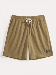Detail showing khaki waffle texture fabric and elastic drawstring on men's casual shorts