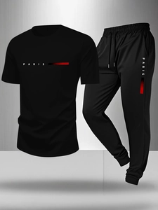 Detail of black sports suit showing Paris lettering and gradient stripes on fabric