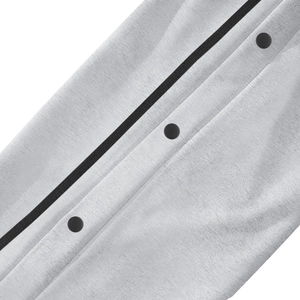 Detailed close-up of high-quality knit fabric texture with three black metal snap buttons