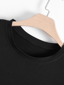 Detail of the crew neck collar and fabric texture of the black outdoor sports shirt
