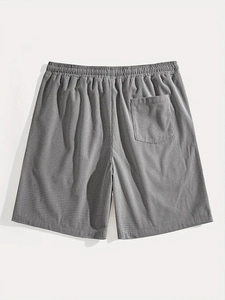 Detailed close-up of white waffle texture fabric and elastic waistband on men's casual shorts