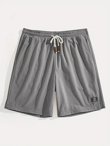 Detail of gray waffle texture shorts with elastic waistband and leather cord tips
