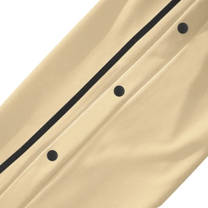 Detailed macro view of black snap buttons on beige vintage straight pants for men