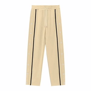Detail of beige casual pants with drawstring waist and side snap button stripe