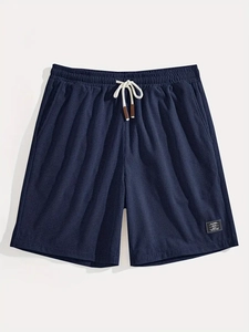 Detailed macro view of dark blue waffle knit fabric texture on men's drawstring shorts