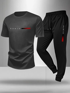 Close-up of dark grey men's sports set with Paris logo and gradient stripes design