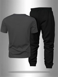 Detail view of breathable men's sports set featuring a grey t-shirt and black joggers