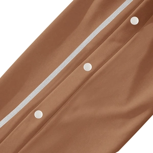 Detailed macro view of brown jogger fabric with white buttons and stripe accents