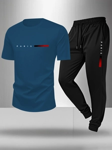 Detail of navy blue t-shirt and black pants with Paris logo and stripe pattern